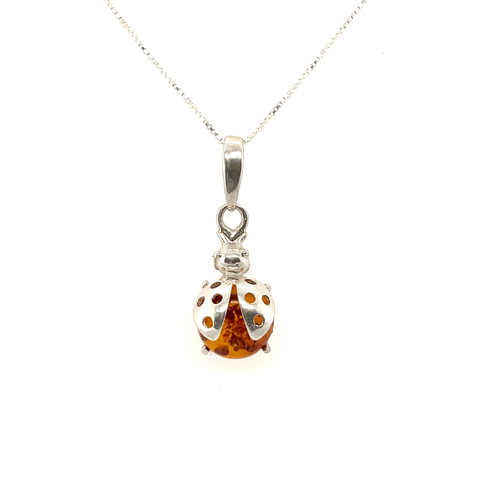 A Super Silver necklace with an Amber Ladybug Pendant, symbolizing protection.