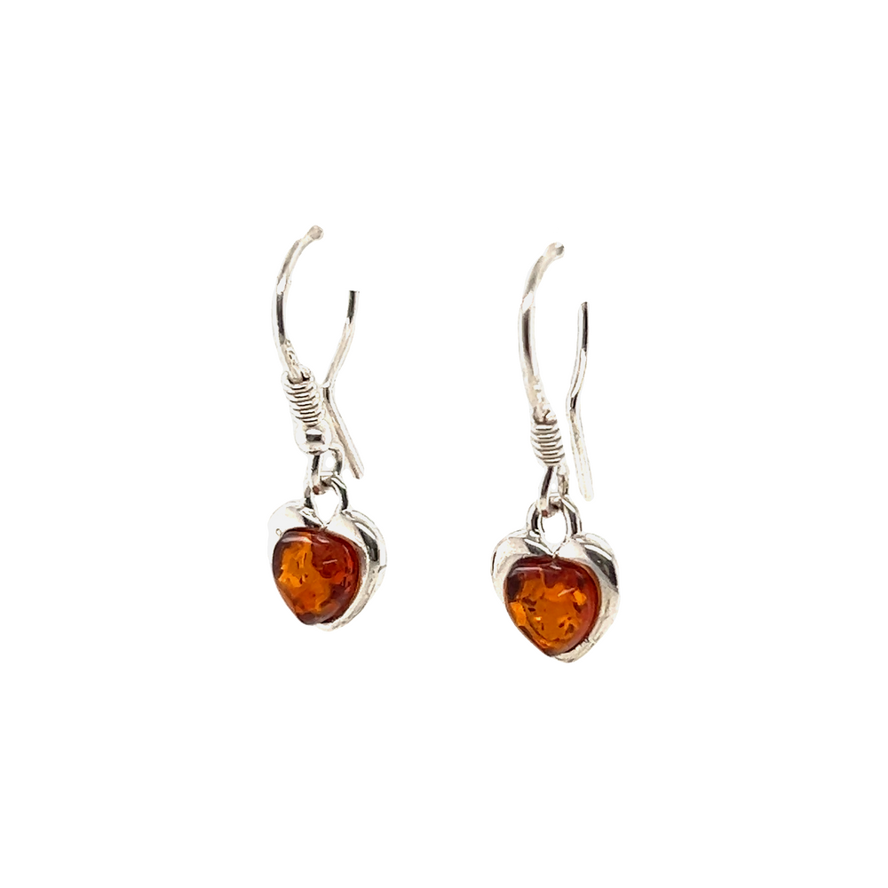 These Dainty Amber Heart Earrings are crafted from sterling silver and showcase the soothing properties of amber, promoting self-confidence. Made by Super Silver.