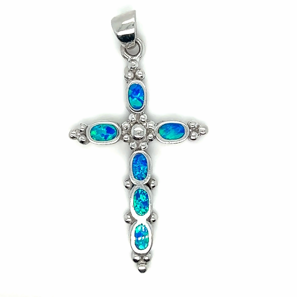 
                  
                    A Super Silver Blue Opal Cross Pendant With Oval Stones adorned with dazzling blue opal stones.
                  
                