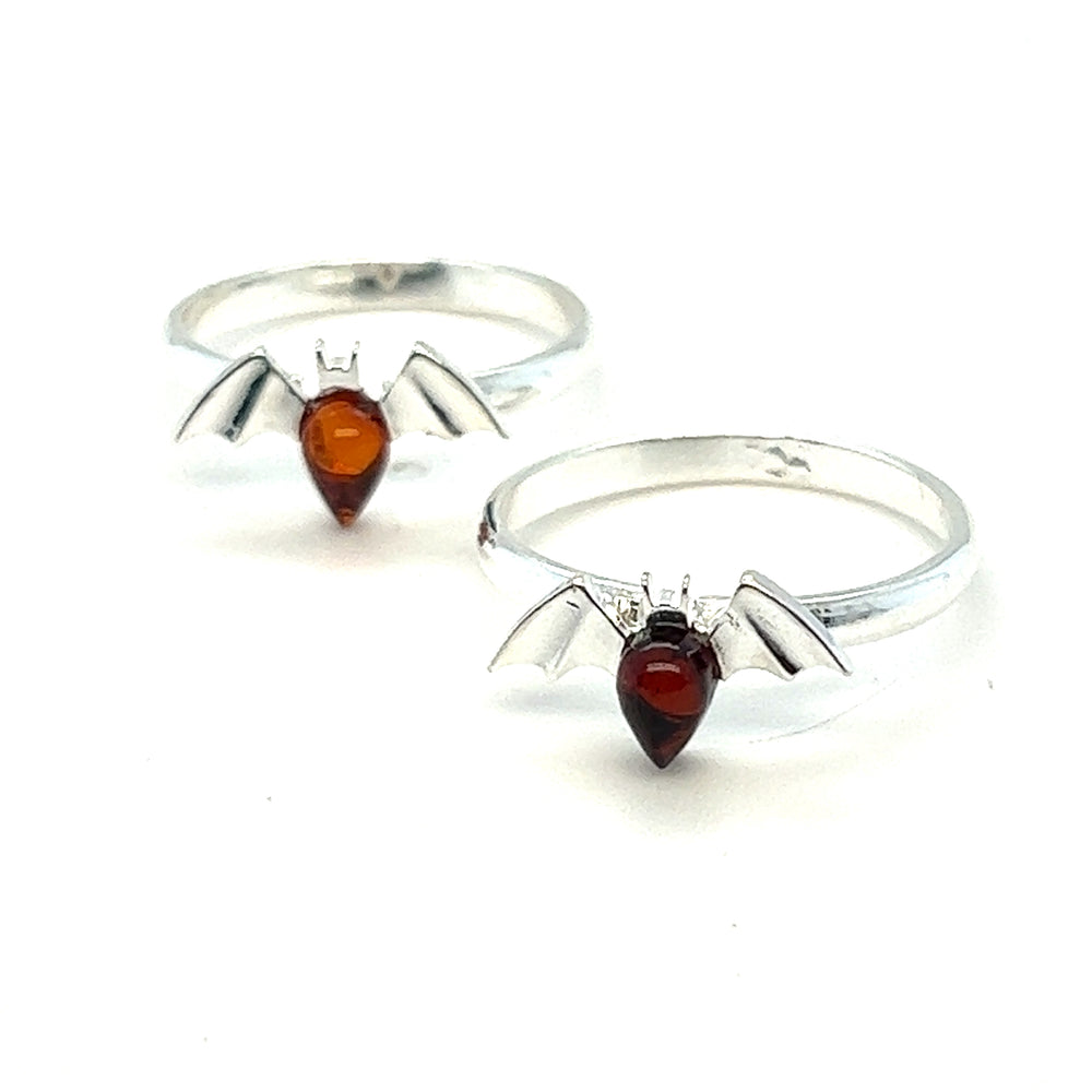 Two Super Silver Baltic Amber Bat rings with Baltic amber stones on them.
