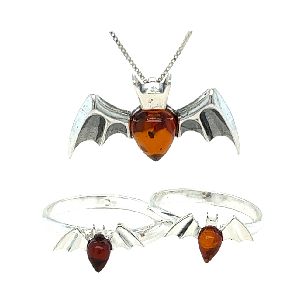 
                  
                    A stunning set of Haunting Amber Bat Pendant earrings, necklace, and ring made with exquisite Baltic amber in rich cognac colors by Super Silver.
                  
                