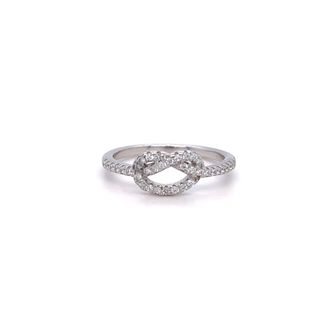 A white gold engagement ring with diamonds and the Cubic Zirconia Pretzel Knot Ring accents.