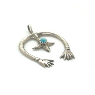 
                  
                    A Super Silver Native American Naja Pendant With Turquoise adorned with a captivating turquoise stone.
                  
                