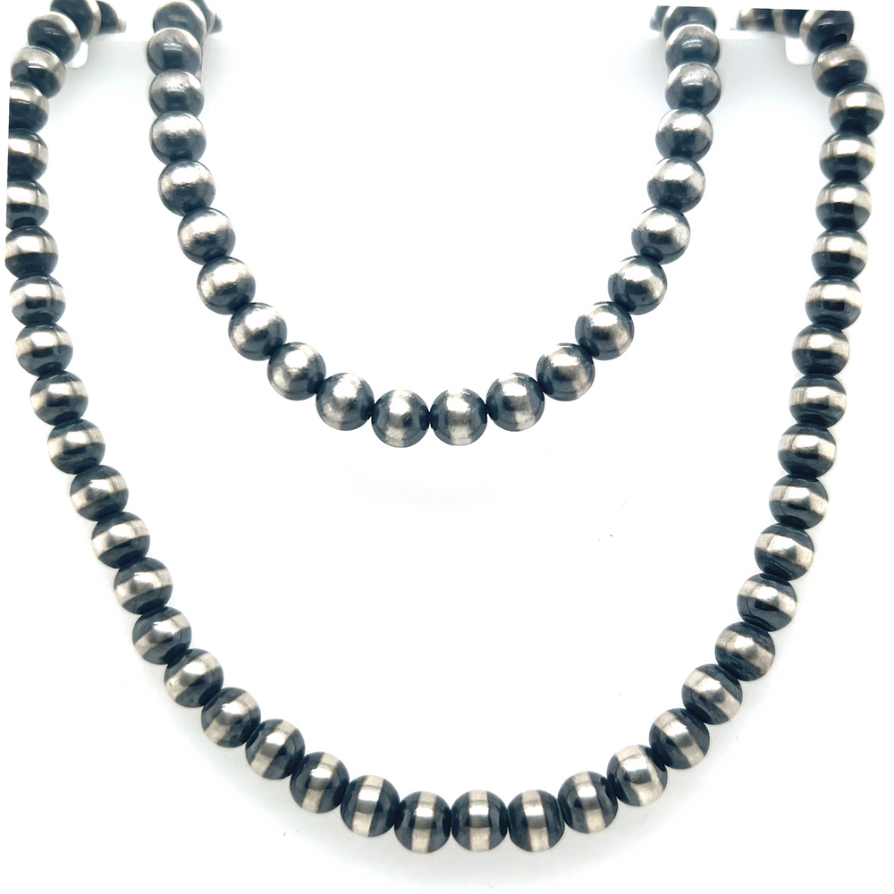 
                  
                    A vintage vibe Super Silver Navajo Pearl Necklace with black beads.
                  
                