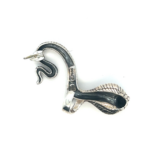 
                  
                    A Unique Cobra Ear Cuff in silver and black on a white surface from the brand Super Silver.
                  
                