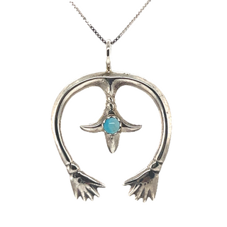
                  
                    A Super Silver Native American Naja Pendant With Turquoise, perfect for adding a touch of southwest charm to any outfit.
                  
                