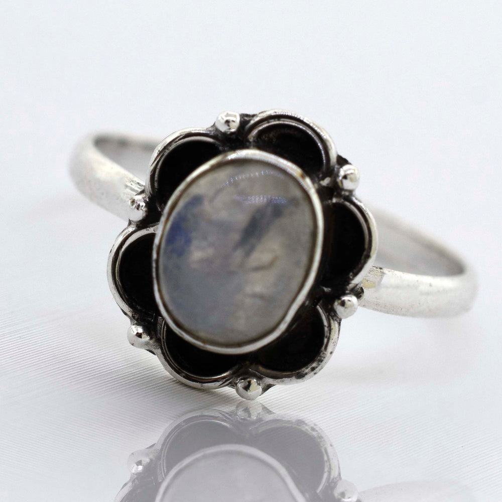 
                  
                    An exquisite Gemstone Ring With Oxidized Flower Design from Super Silver, with a central blue gemstone.
                  
                