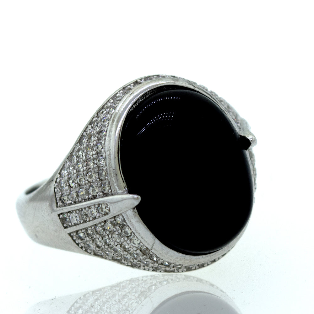
                  
                    An elegant Onyx And Cubic Zirconia ring on a white background.
                  
                