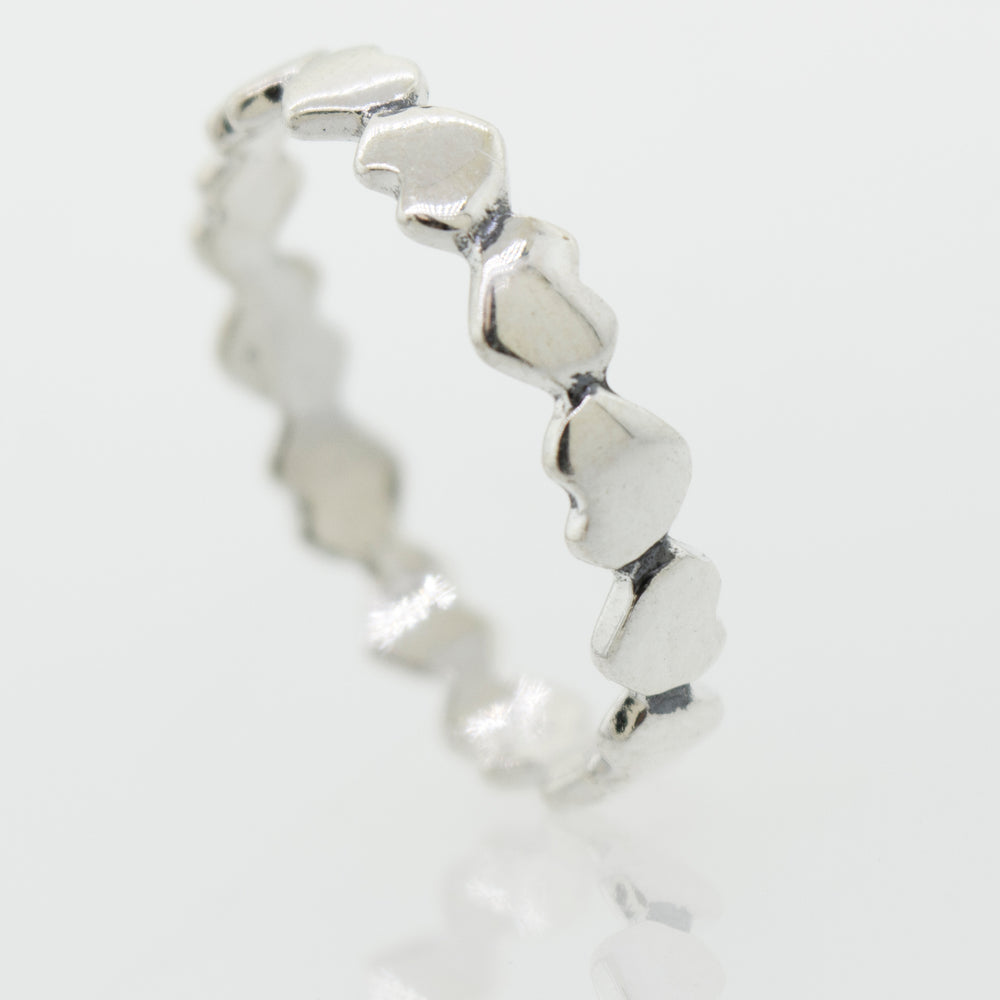 
                  
                    A sterling silver Hearts Band With Alternating Pattern ring, perfect for stacking.
                  
                