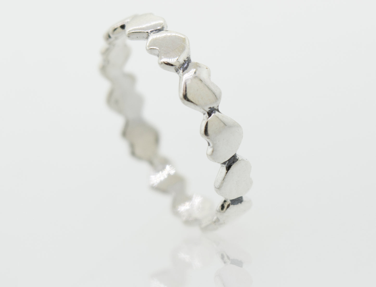 
                  
                    A sterling silver Hearts Band With Alternating Pattern ring, perfect for stacking.
                  
                