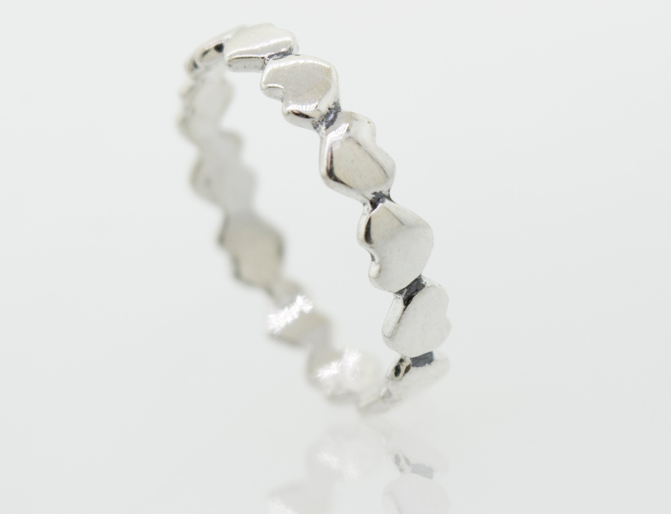 A sterling silver Hearts Band With Alternating Pattern ring, perfect for stacking.