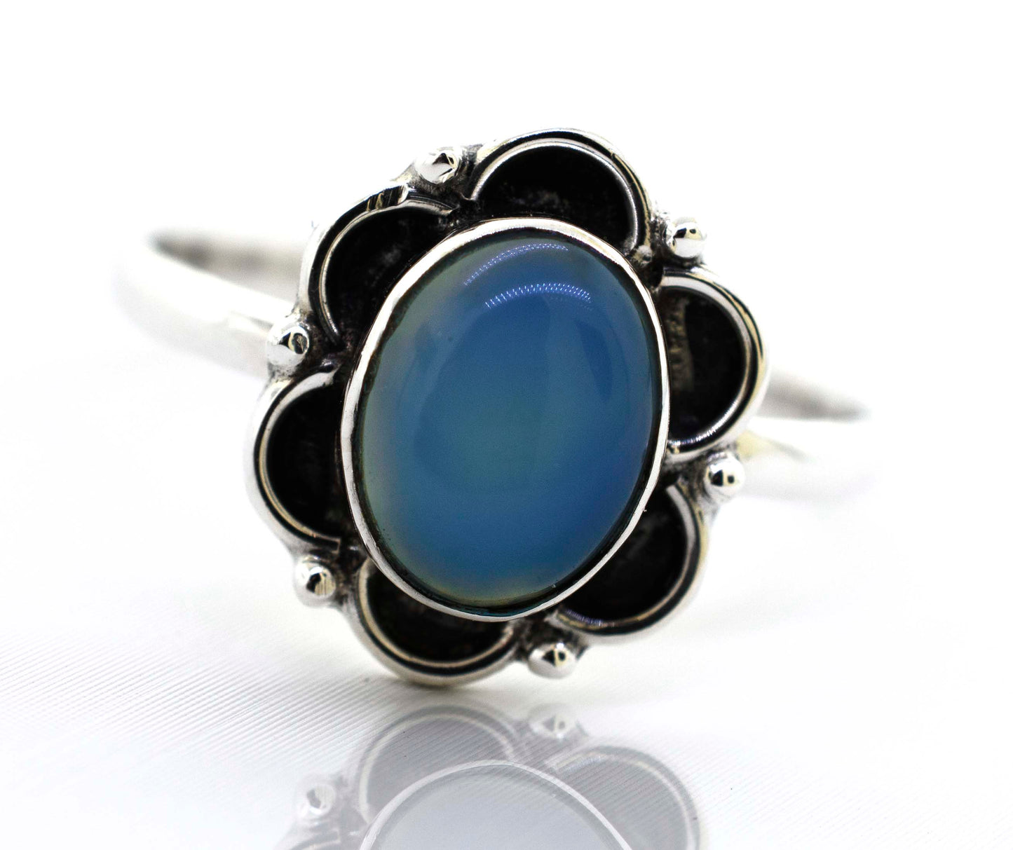 
                  
                    A delicate Super Silver gemstone ring with an oxidized flower design.
                  
                
