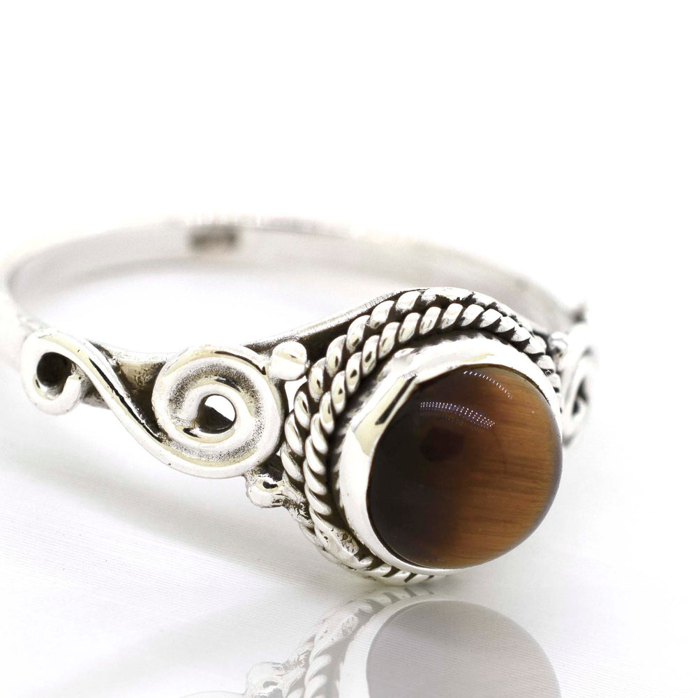 
                  
                    A bohemian vibe meets modern elegance with this Super Silver .925 sterling silver gemstone circle ring featuring a stunning tiger eye stone.
                  
                