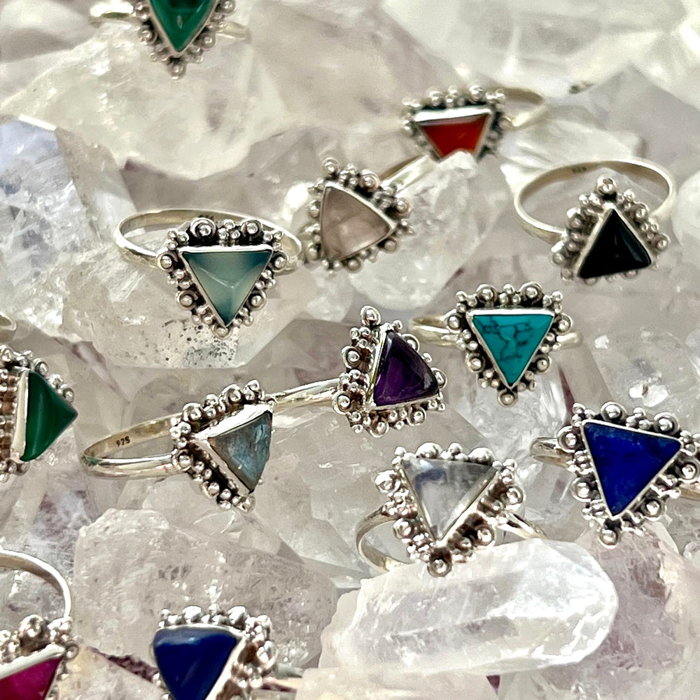 
                  
                    A group of Delicate Gemstone Triangle Rings with different colored stones on them, perfect for the Santa Cruz vibe.
                  
                