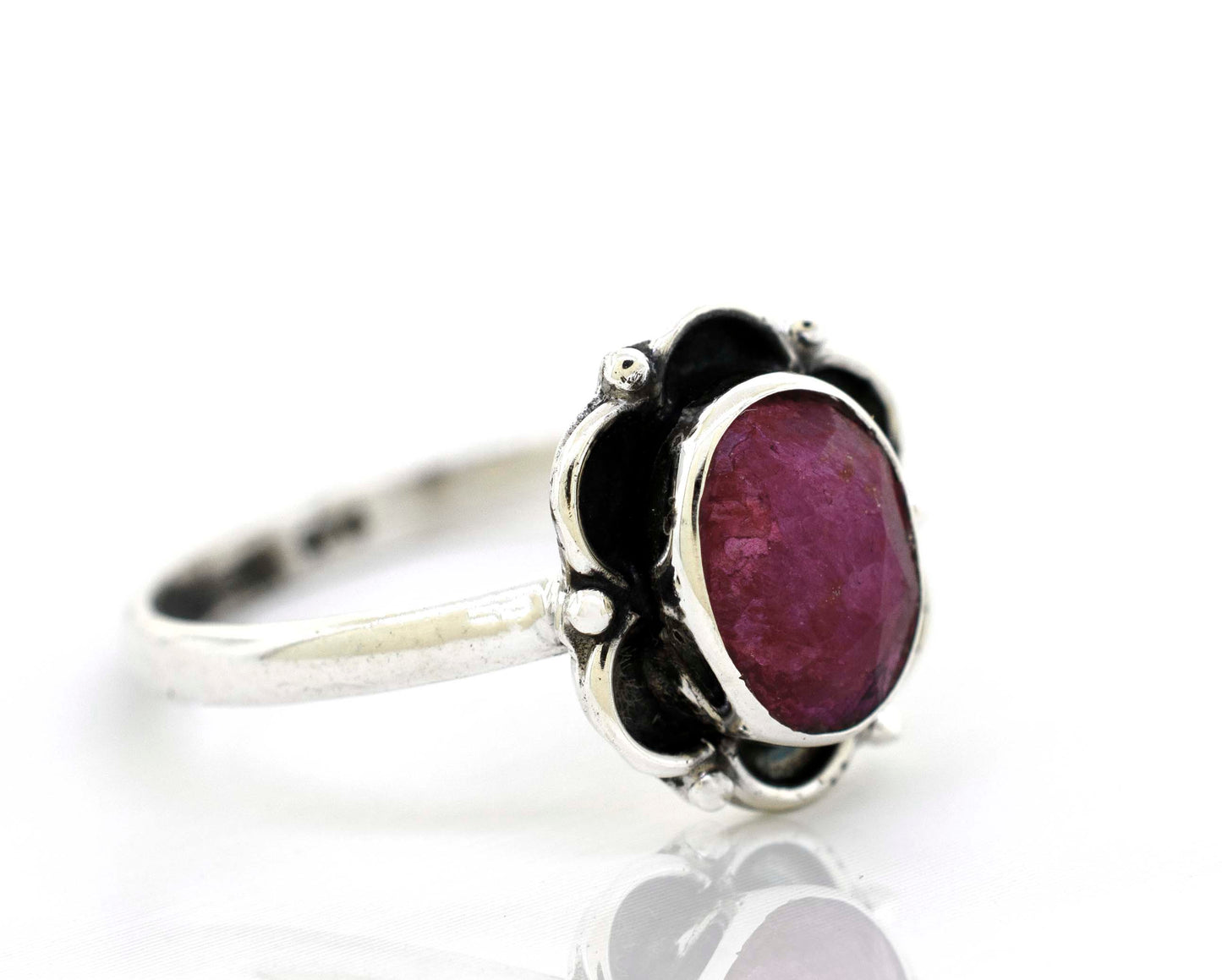 
                  
                    Super Silver's Gemstone Ring With Oxidized Flower Design delicately encases a central ruby gemstone, creating a stunning flower petal ring.
                  
                