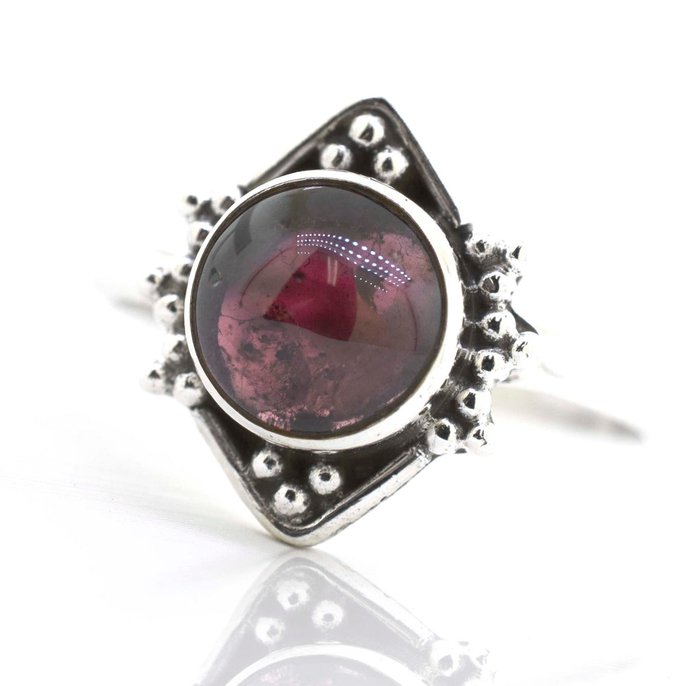 
                  
                    This Round Gemstone Ring With Oxidized Diamond Shape Pattern from Super Silver features a stunning red gemstone.
                  
                