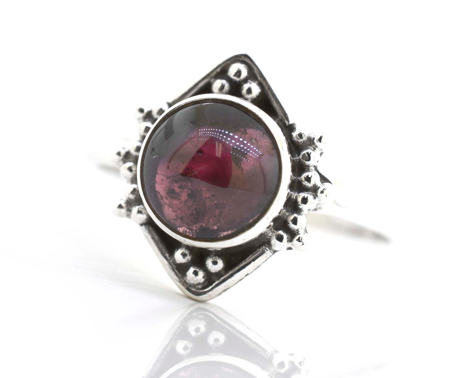 
                  
                    This Round Gemstone Ring With Oxidized Diamond Shape Pattern from Super Silver features a stunning red gemstone.
                  
                