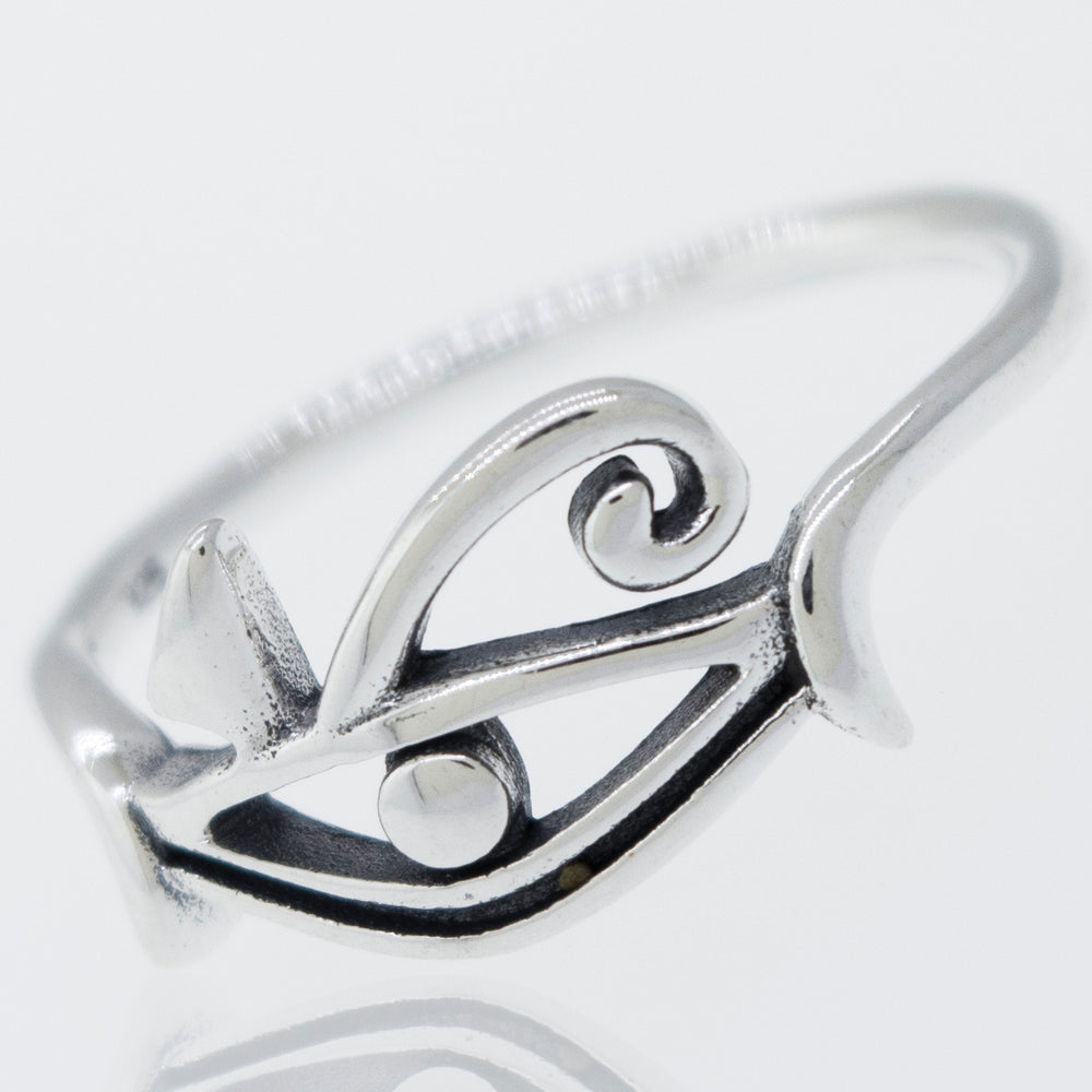 An Eye of Horus Ring on a white surface.