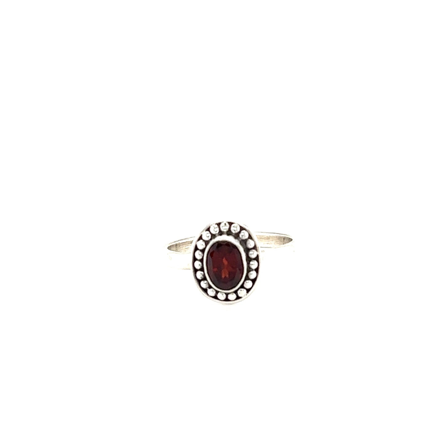 
                  
                    An Oval Gemstone Ring with Ball Disk Border with a sterling silver band and a cabochon garnet stone surrounded by dazzling diamonds.
                  
                