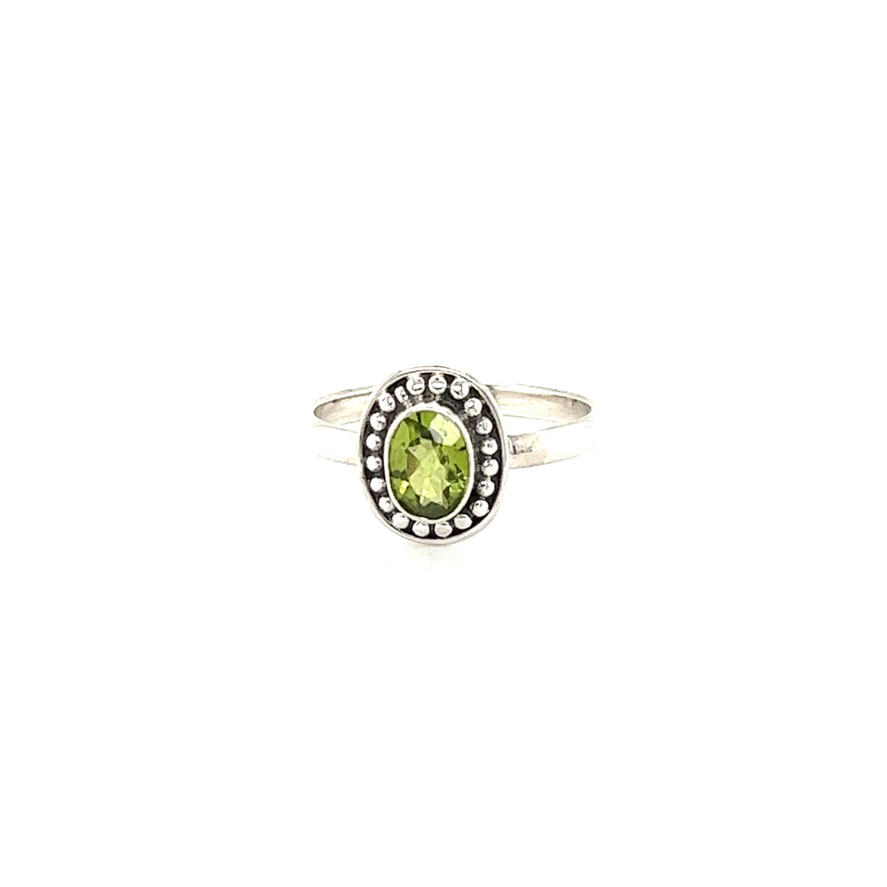 
                  
                    A oval gemstone ring with ball disk border with diamond accents.
                  
                