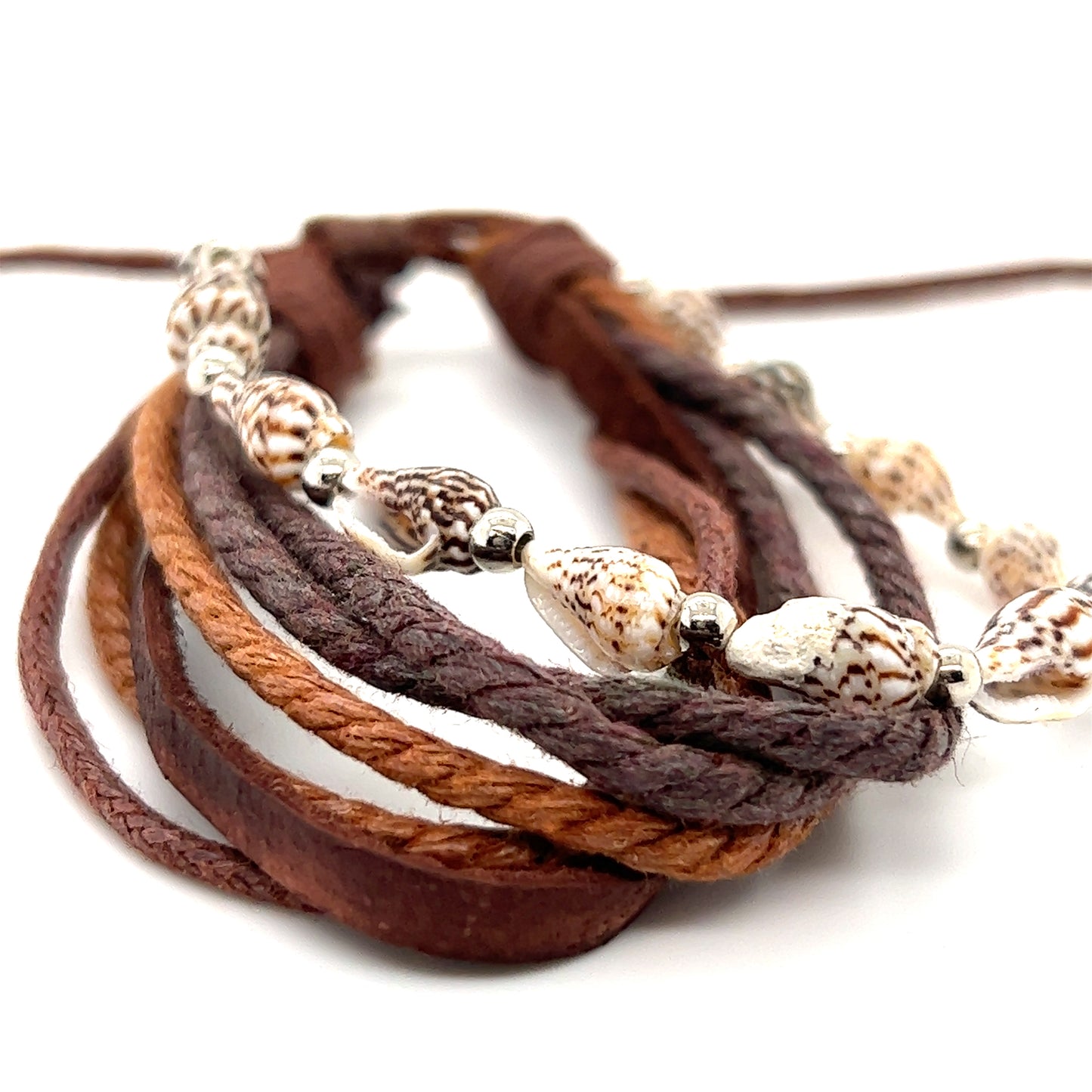 A Super Silver Rope Shell Bracelet with brown leather and sea shells, perfect for everyday wear. The band is adjustable for a comfortable fit.