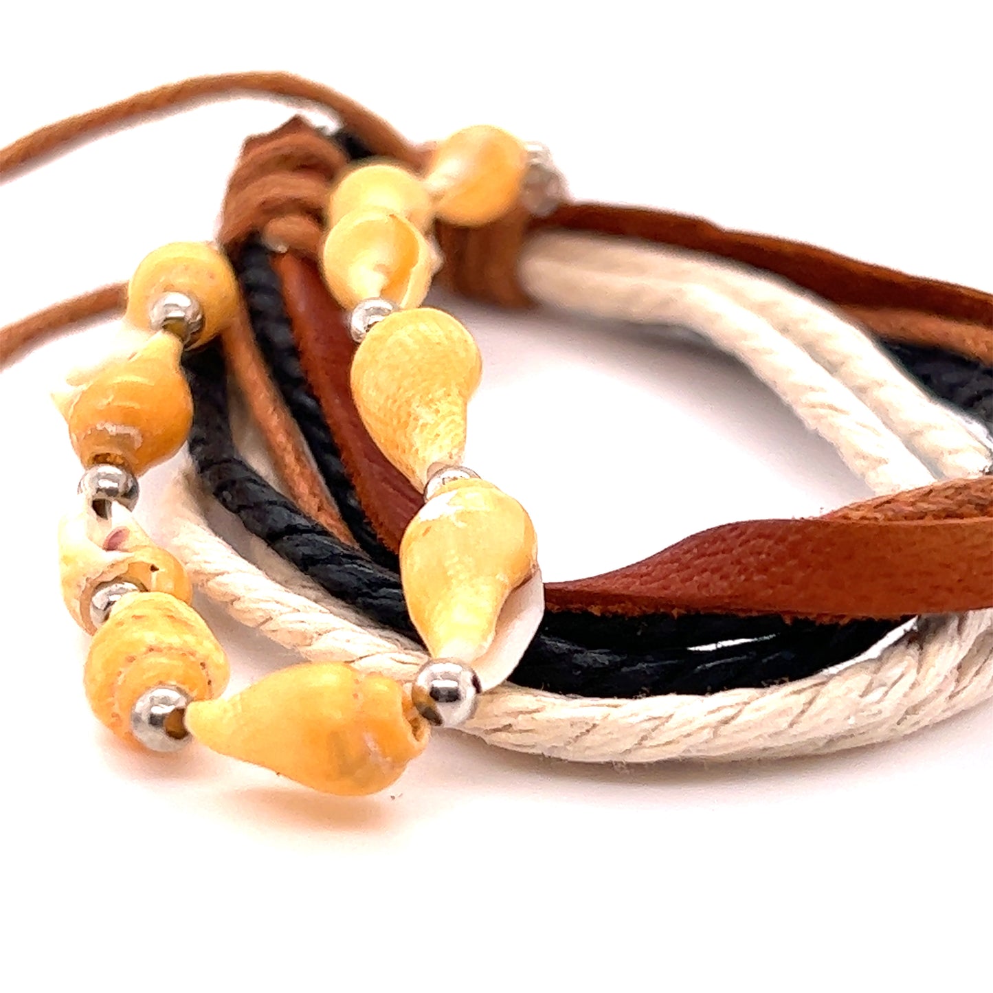 An everyday wear pair of Super Silver Rope Shell bracelets with an adjustable band adorned with earthy yellow and brown beads.