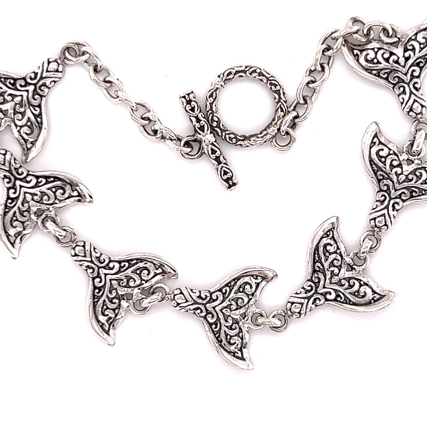 A Stunning Whale Tail Bracelet with ornate designs inspired by Santa Cruz oceanic motifs crafted by Super Silver.