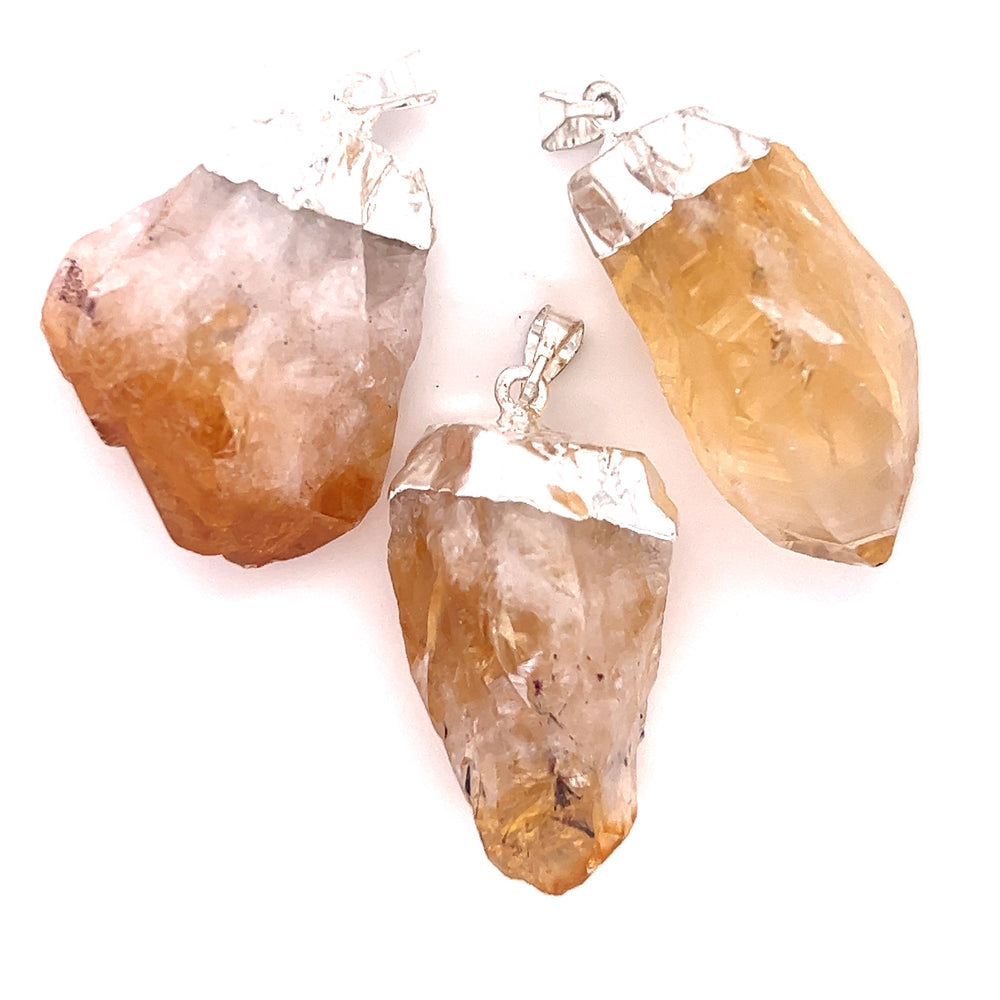 
                  
                    Three pieces of Super Silver's Raw Crystal Pendant With Silver Cap on a white background.
                  
                