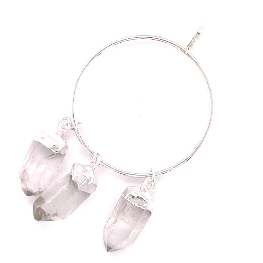 
                  
                    A Super Silver hoop adorned with three Raw Quartz on Ring Pendants, perfect for everyday layering.
                  
                