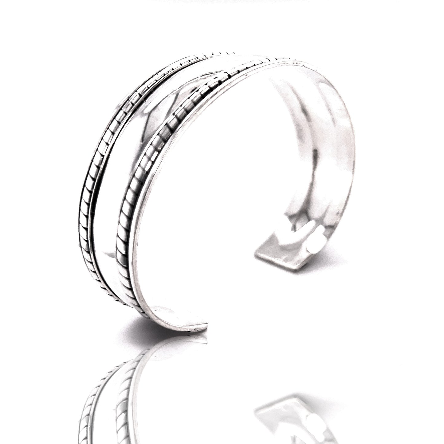 A Super Silver domed silver cuff bracelet with rope etching on a white surface.