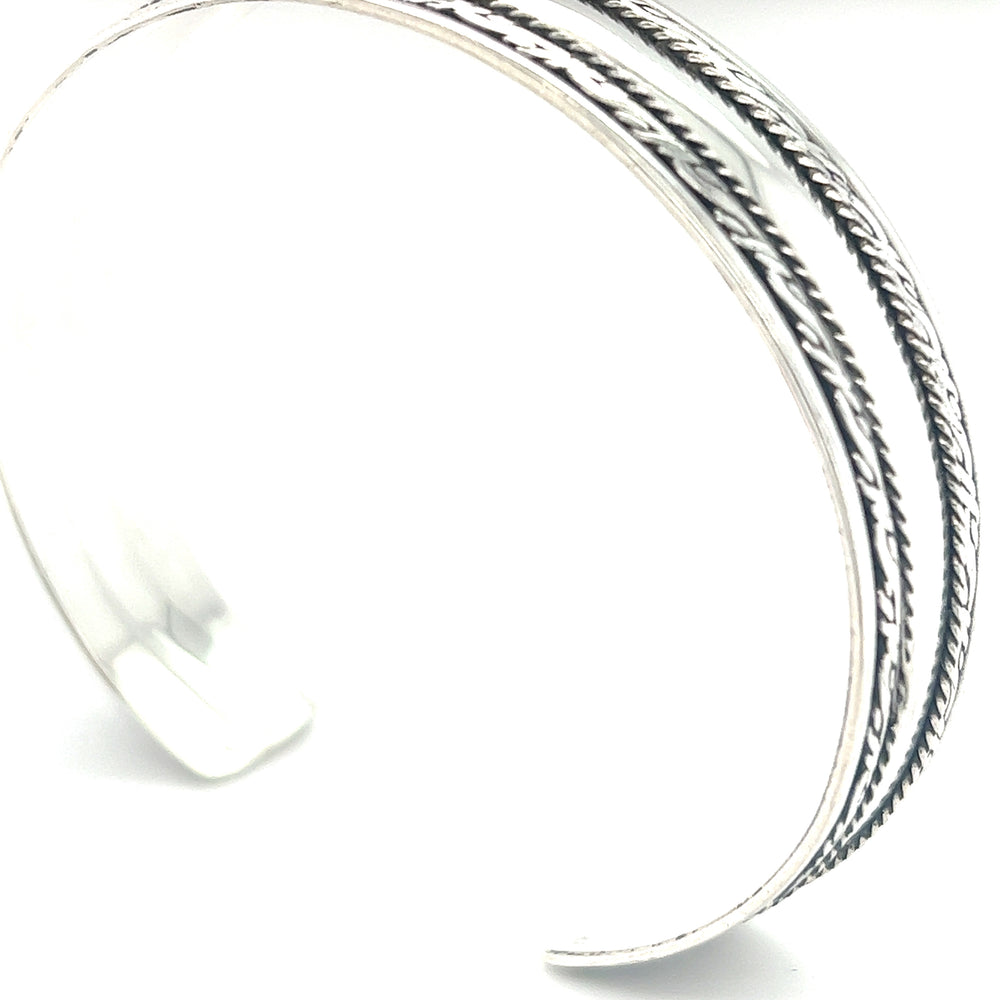 
                  
                    A Super Silver silver domed cuff bracelet with a rope pattern, perfect for stacking and inspired by the beautiful designs of Bali.
                  
                