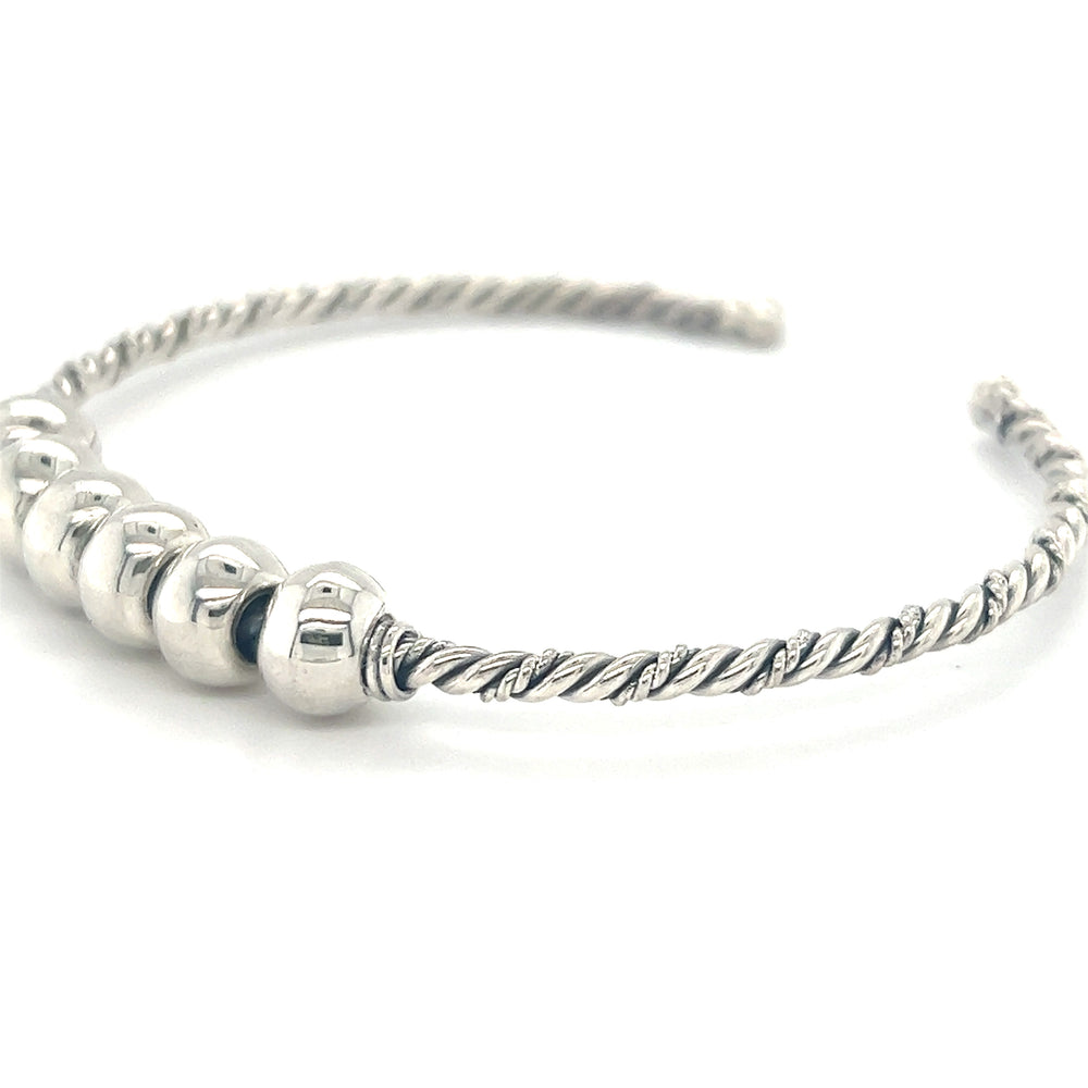 
                  
                    A Super Silver Handmade Twisted Cuff with Balls bracelet, featuring four silver beads, giving it an antique look.
                  
                