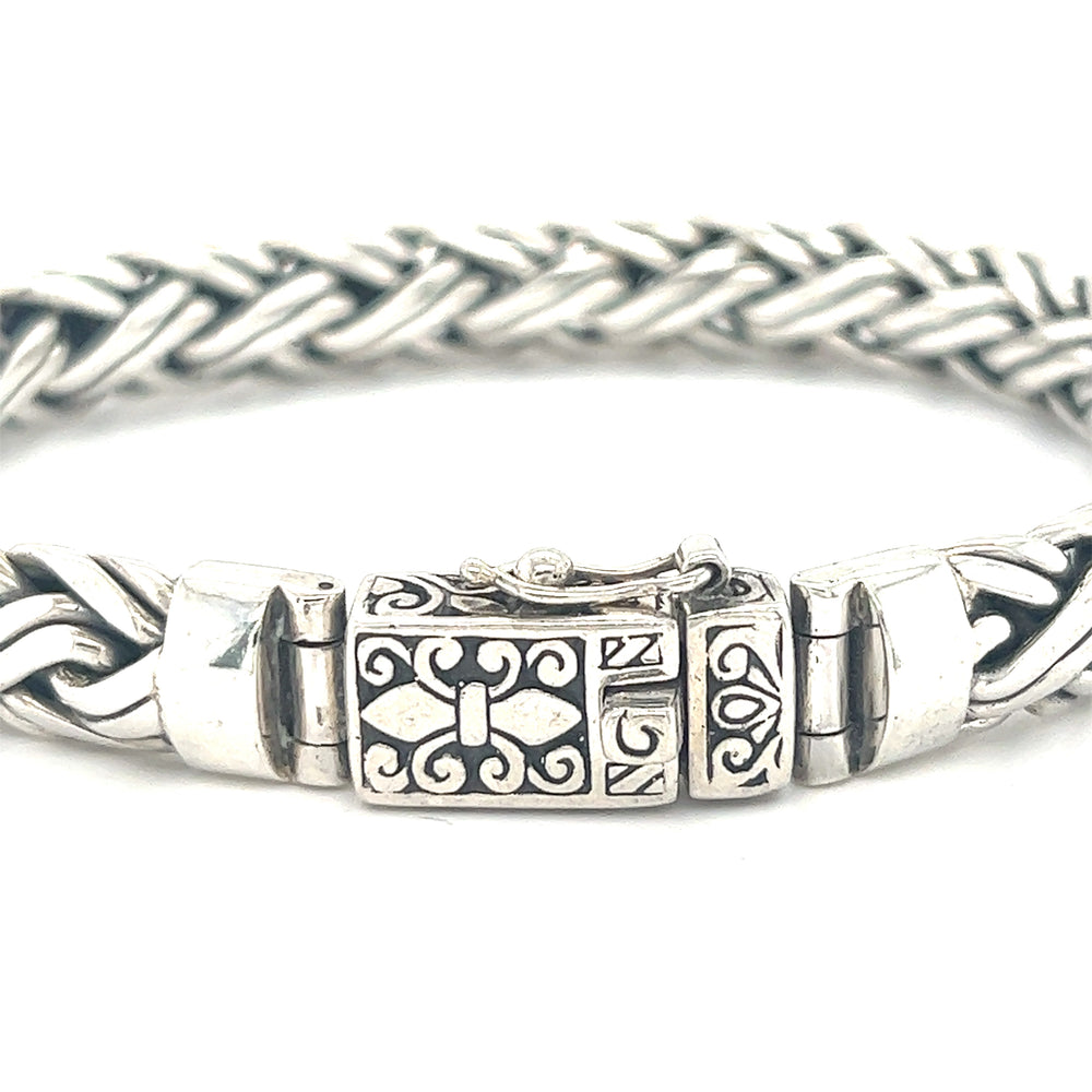 A Heavy Double Strand Braided Bracelet with a cross on it, serving as a statement piece and conversation starter by Super Silver.