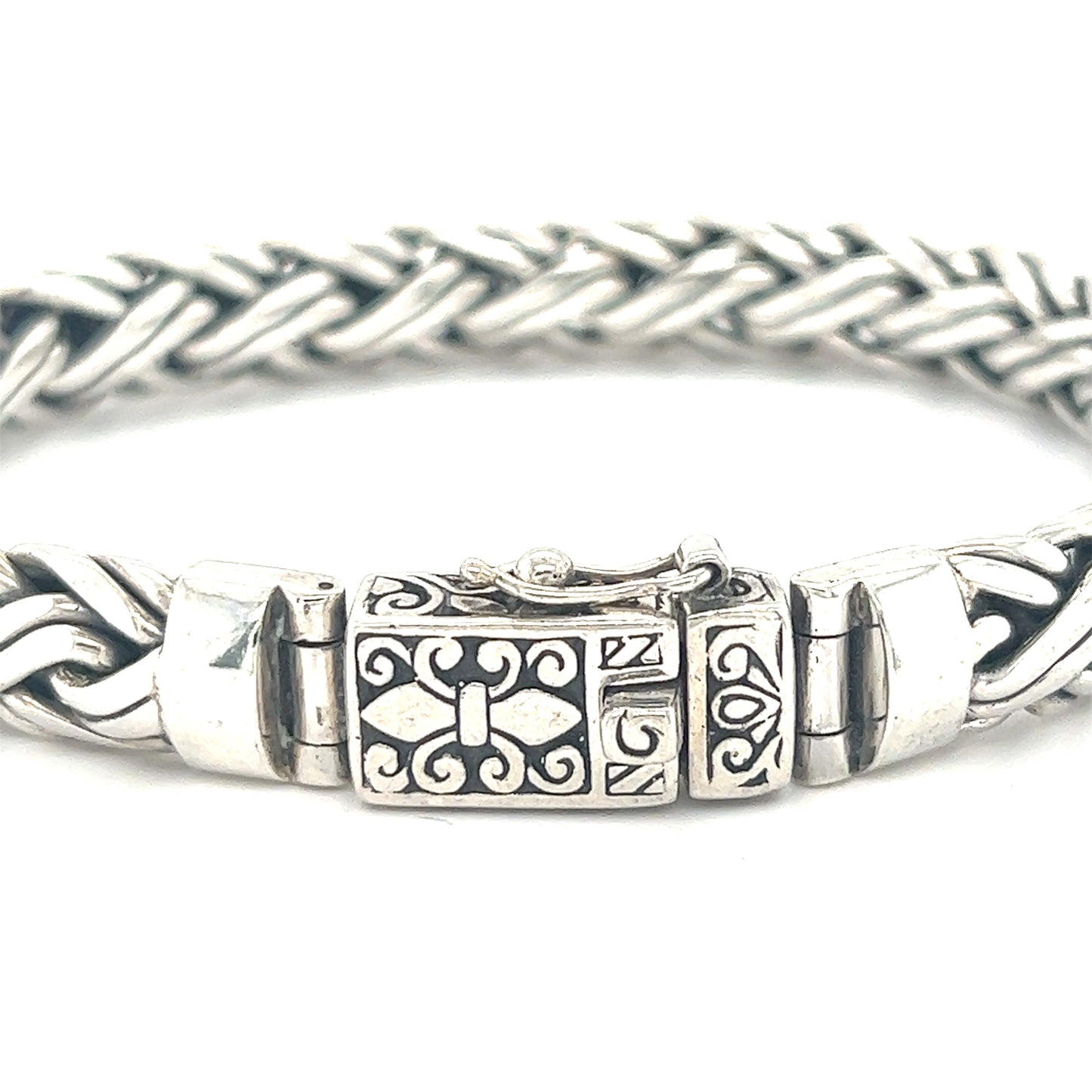 
                  
                    A detailed clasp secures this Heavy Sterling Silver Braided Bracelet by Super Silver with a cross on it.
                  
                