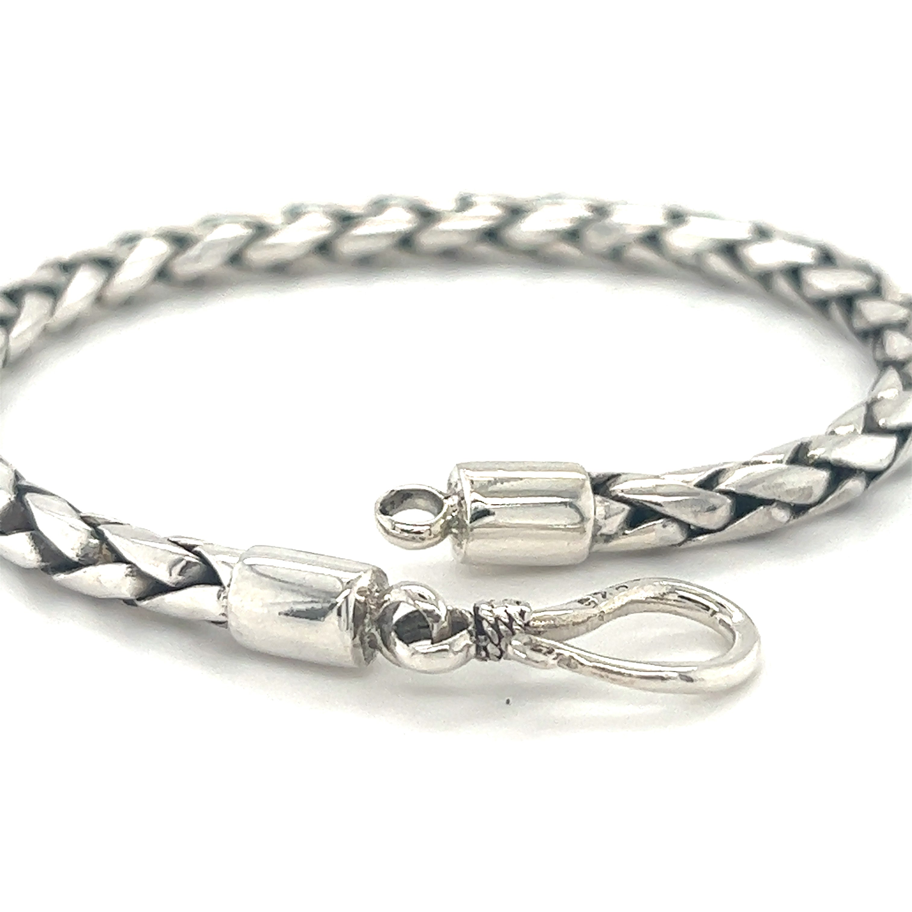 Close-up of a 4mm Bright Rope Bracelet with cylindrical end caps and a hook clasp. The bracelet has a bright finish and looks neatly crafted, resembling a woven rope bracelet.