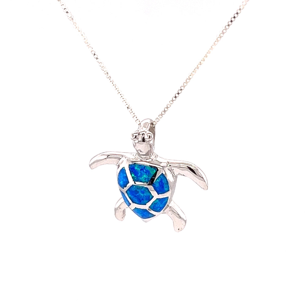 A Super Silver Opal Sea Turtle Pendant adorned with a mesmerizing blue opal stone.