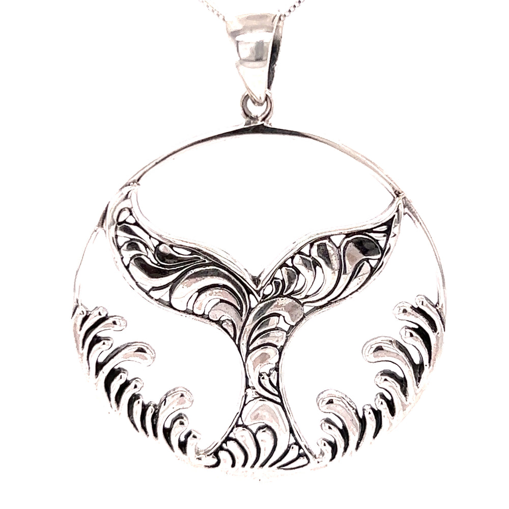
                  
                    A Super Silver Magnificent Whale Tail Pendant with Waves, perfect for ocean enthusiasts and residents of Santa Cruz.
                  
                