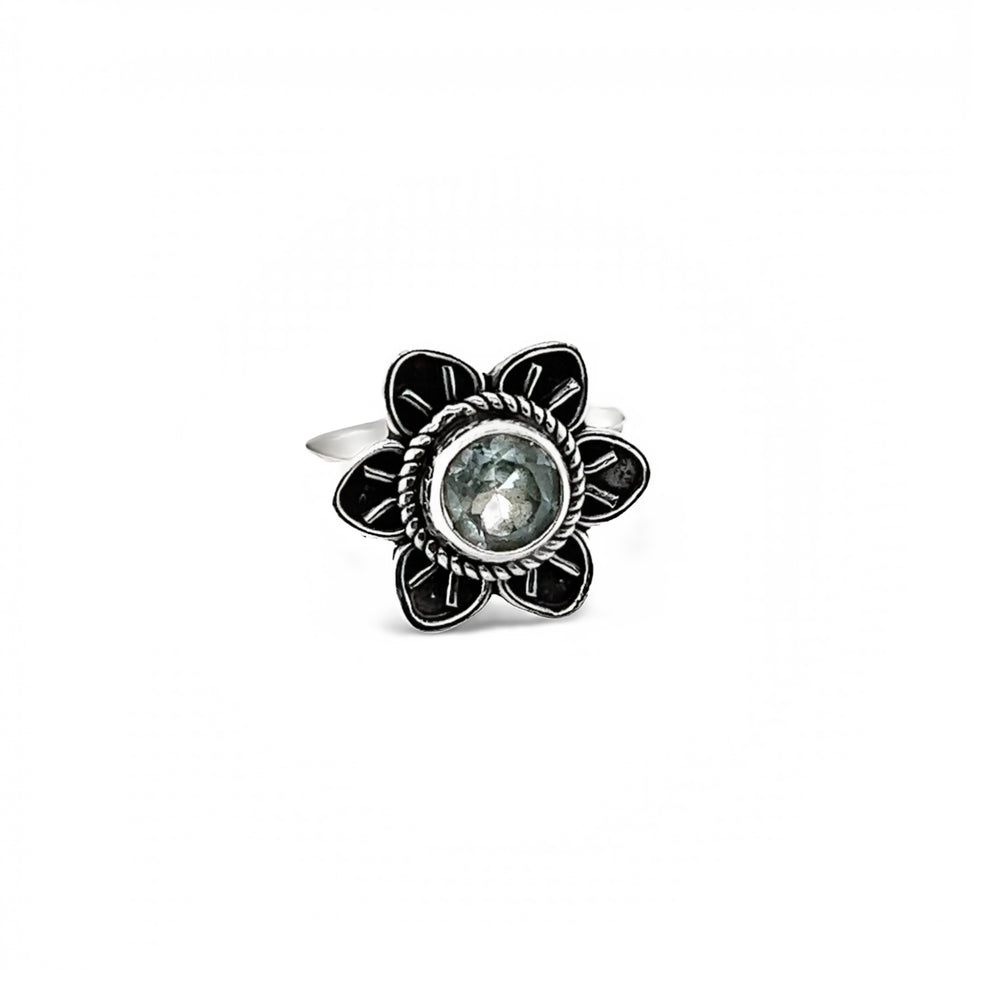 
                  
                    An Enchanting Flower Ring with Natural Gemstones with a blue topaz stone cabochon.
                  
                