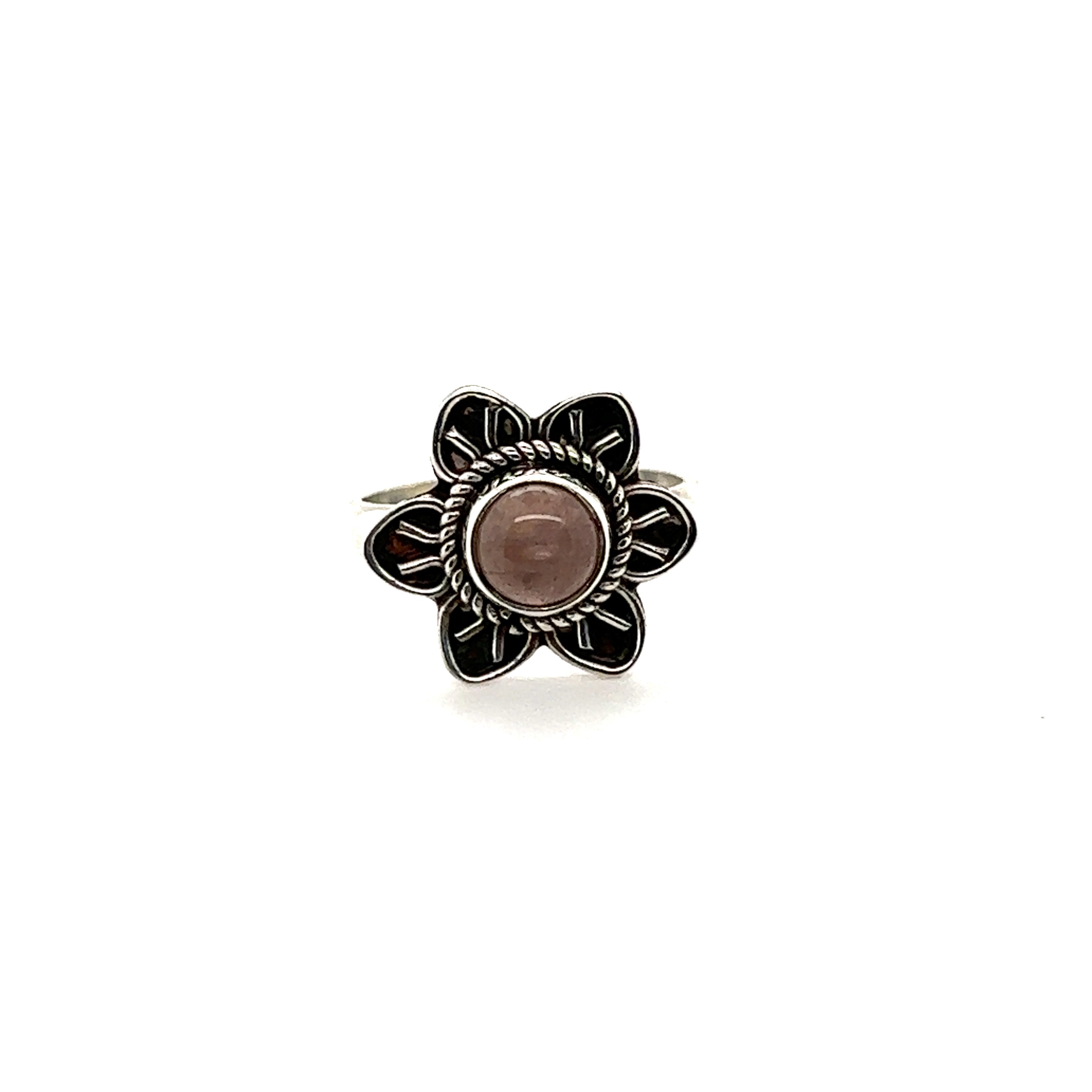 An Enchanting Flower Ring with Natural Gemstones that is boho silver with a pink stone.