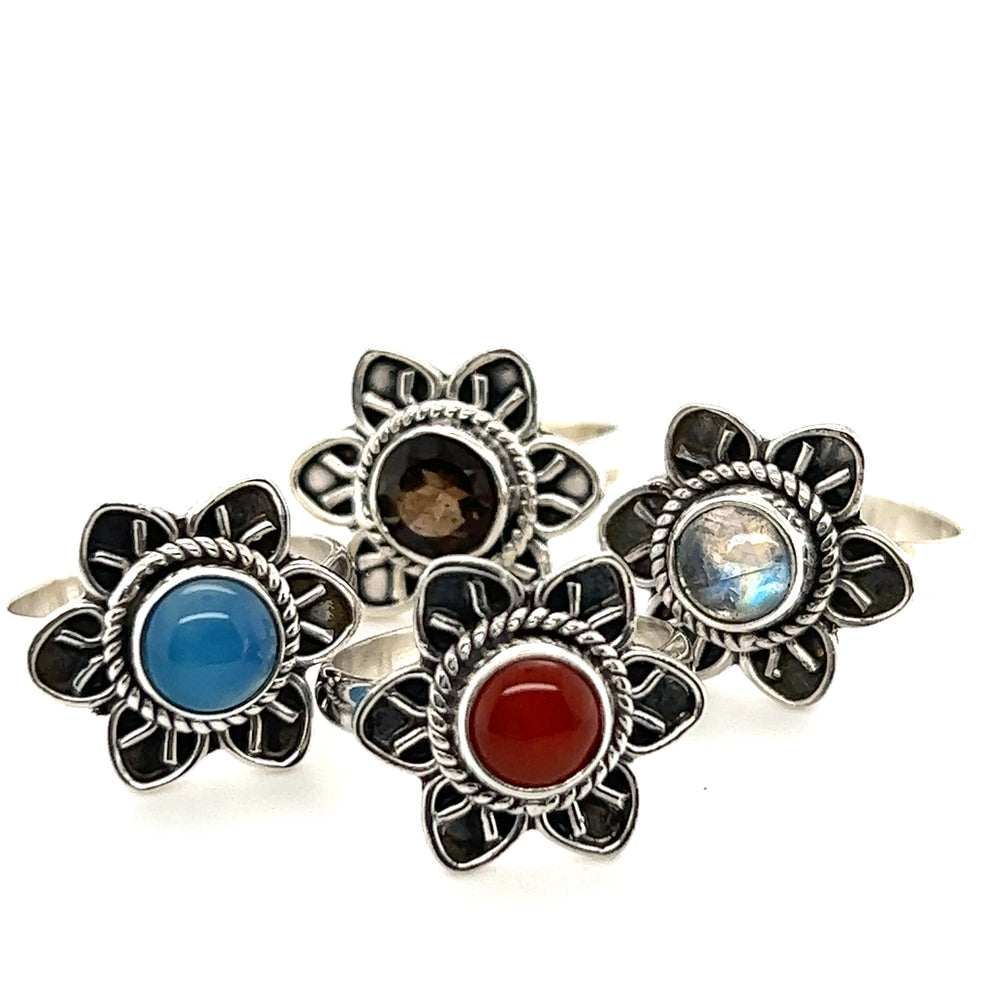 
                  
                    A set of four Enchanting Flower Rings with Natural Gemstones by Super Silver.
                  
                