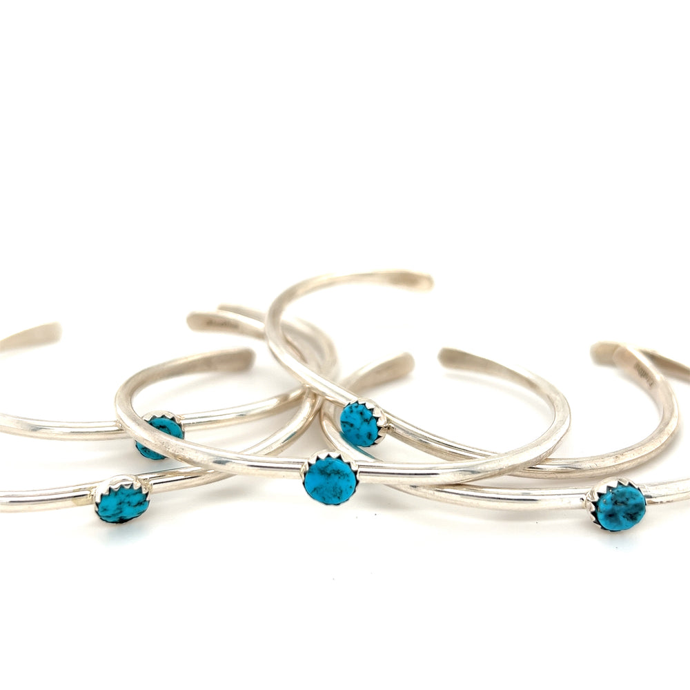 Four Stackable Native American Turquoise Cuff bracelets adorned with Native American Kingman Turquoise stones by Super Silver.