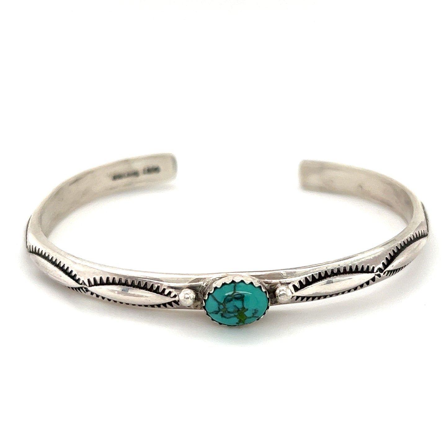 
                  
                    A Super Silver Striking Native American Turquoise Cuff with Diamond Etching adorned with a stunning turquoise stone.
                  
                