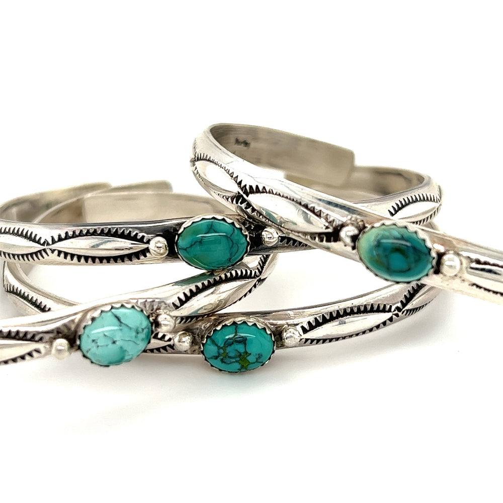 Super Silver's Striking Native American Turquoise Cuff with Diamond Etching cuffs featuring turquoise stones are handmade.