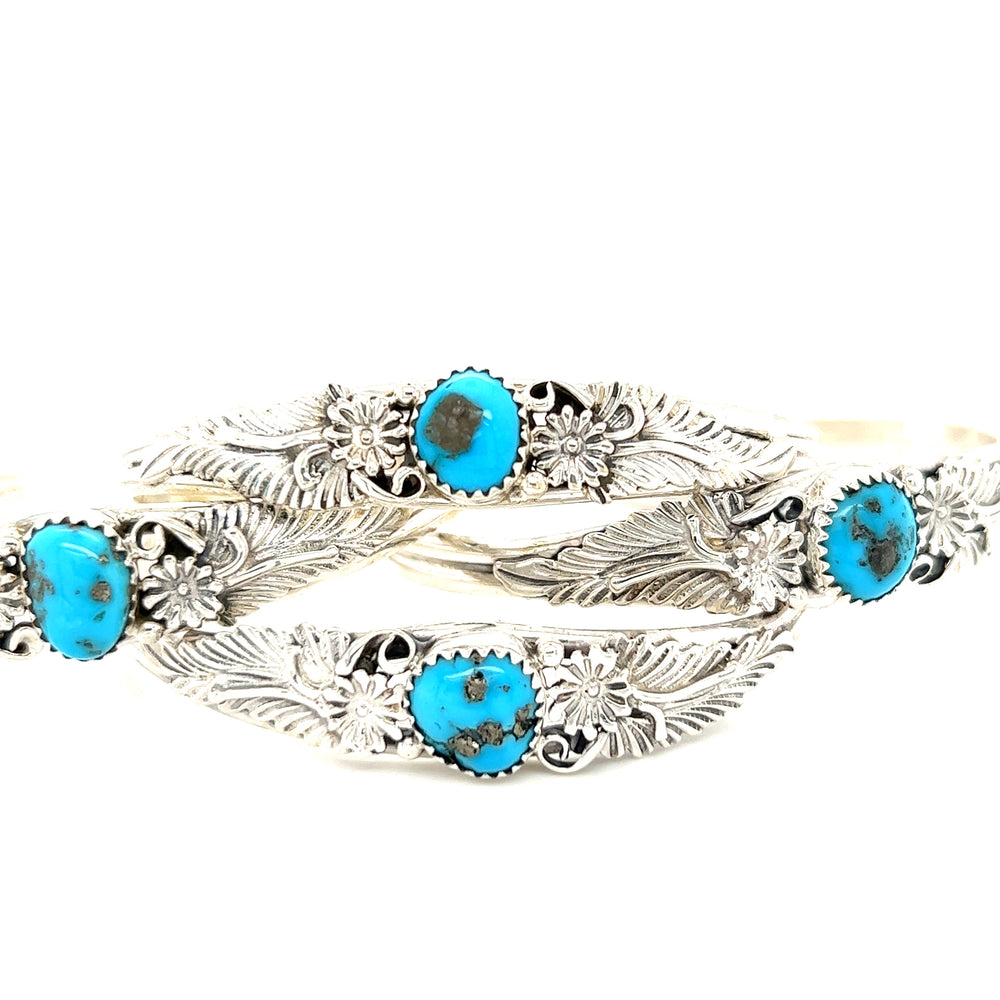 Three silver bracelets with turquoise stones, including a Super Silver Native American Turquoise Cuff with Floral Designs.
