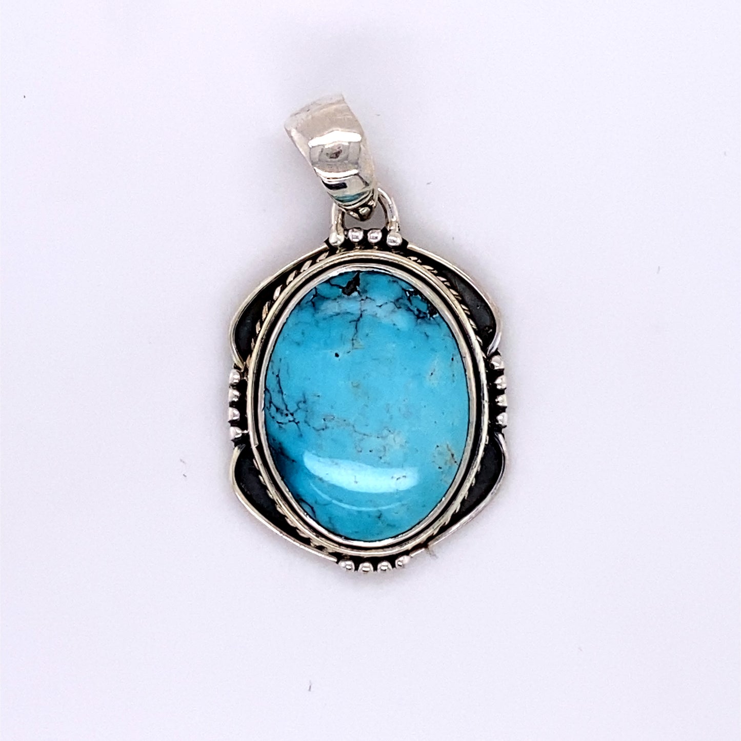 
                  
                    Natural Turquoise Pendant with an Oval Shield Setting
                  
                