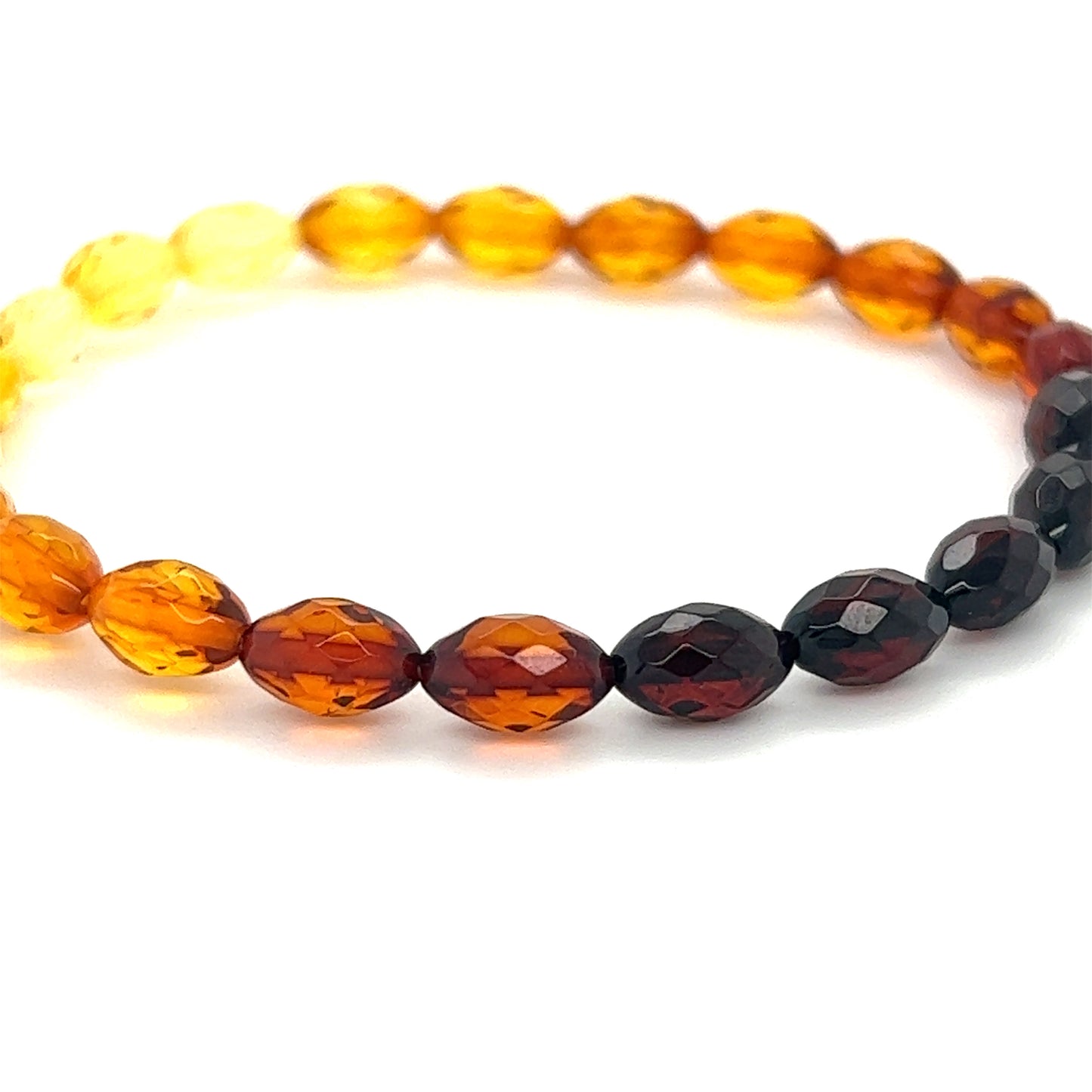 A Super Silver Faceted Baltic Amber Stretch Bracelet with orange, yellow and black amber beads.