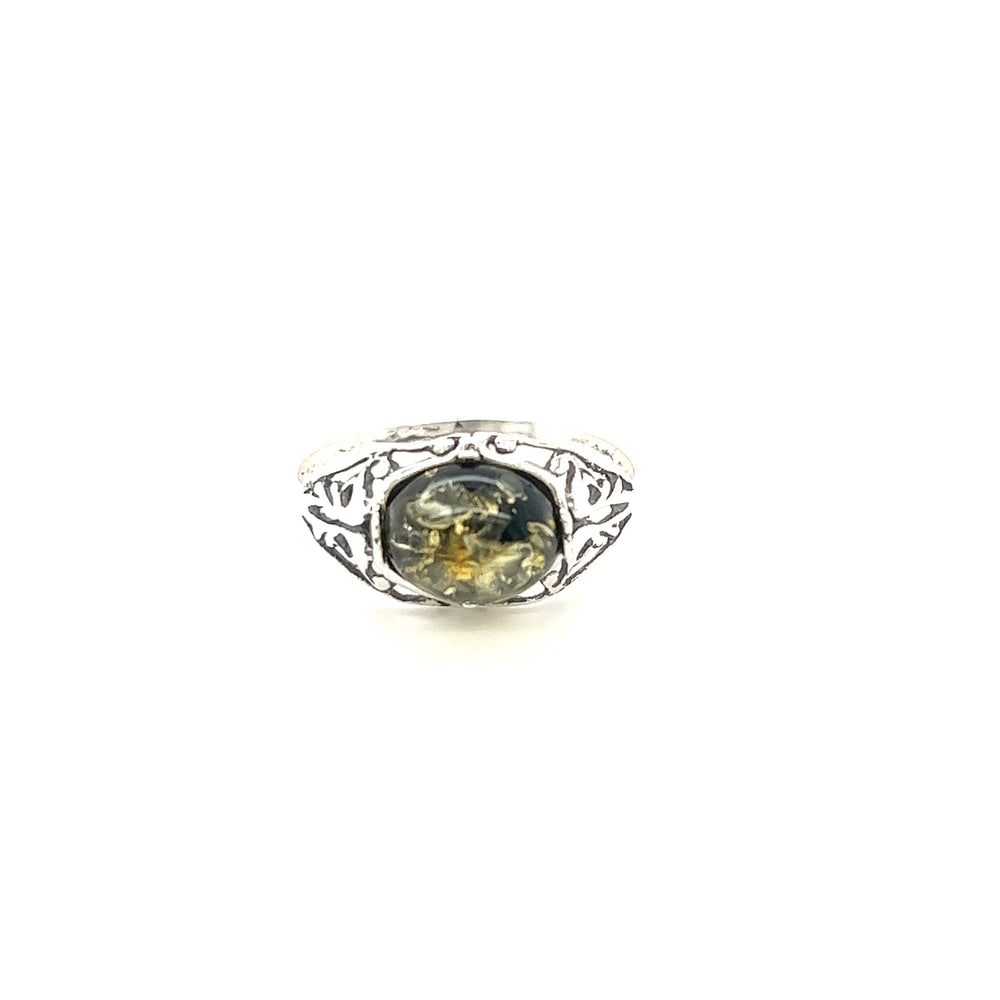 A Super Silver glowing green Baltic amber ring with a black stone in the middle.