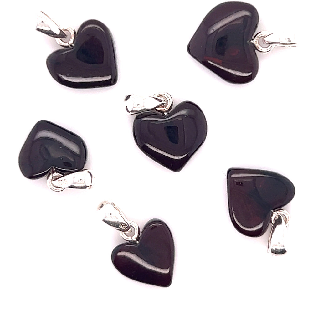 
                  
                    Five Super Silver Charming Baltic Amber Heart Pendants on a white background.
                  
                