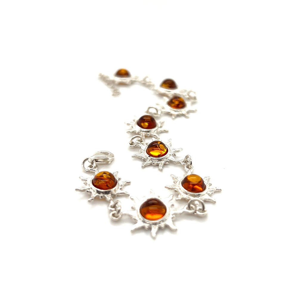 A Sparkling Amber Sun Bracelet adorned with Baltic amber stones and silver sunbursts by Super Silver.