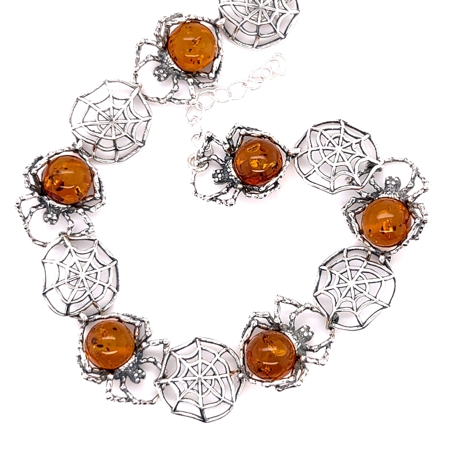A Spellbinding Amber Spider Bracelet with orange bead and intricate silverwork details from Super Silver.